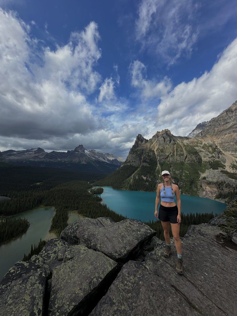 Hales on a mountain summit above a turquoise lake